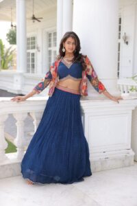 A model wearing blue coloured lehenga with multi-coloured pattern jacket.