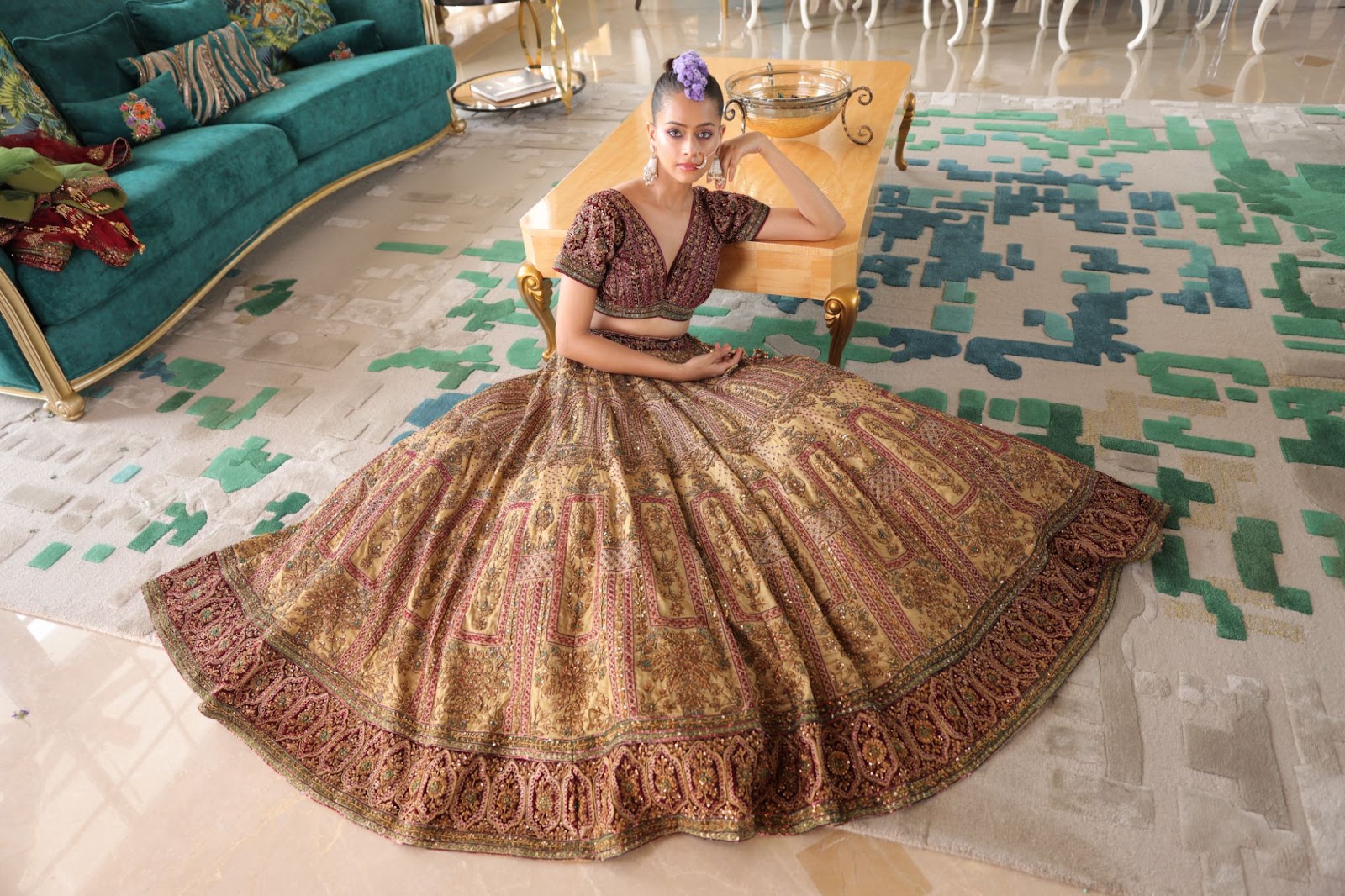 A model wearing sand-coloured golden lehenga with traditional Indian embroidery.